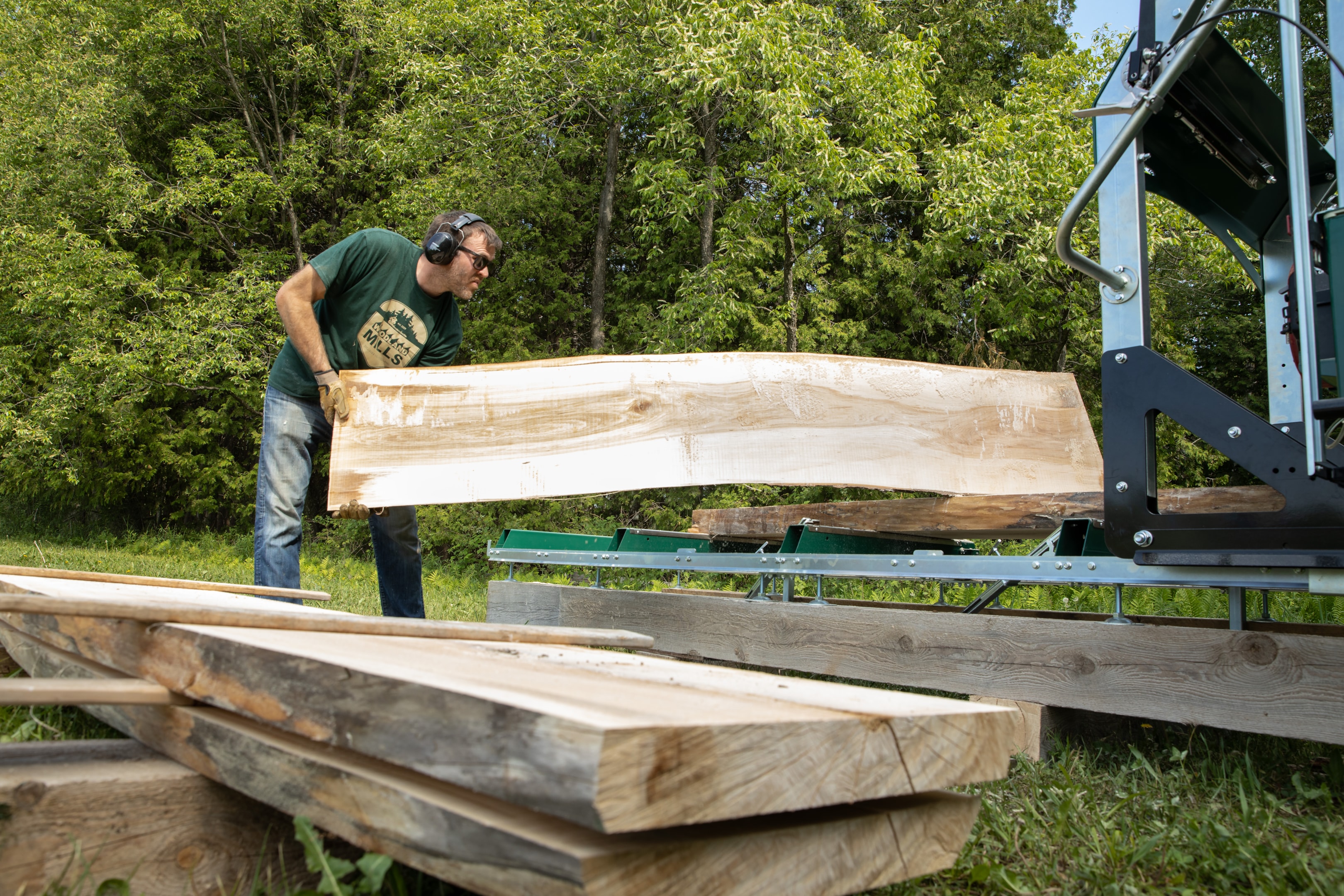 A sawyer with a slab of wood, which in a good market can sell for hundreds of dollars.