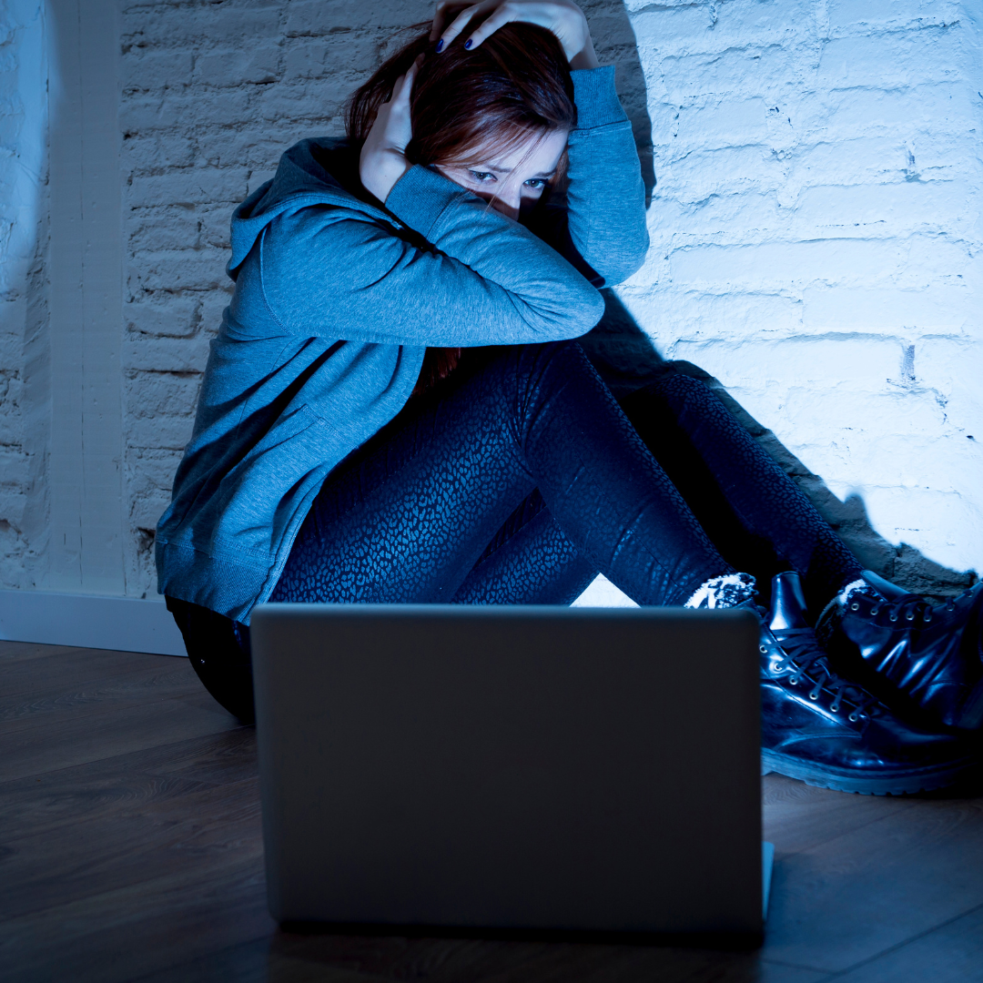 girl in front of laptop looking visibly upset