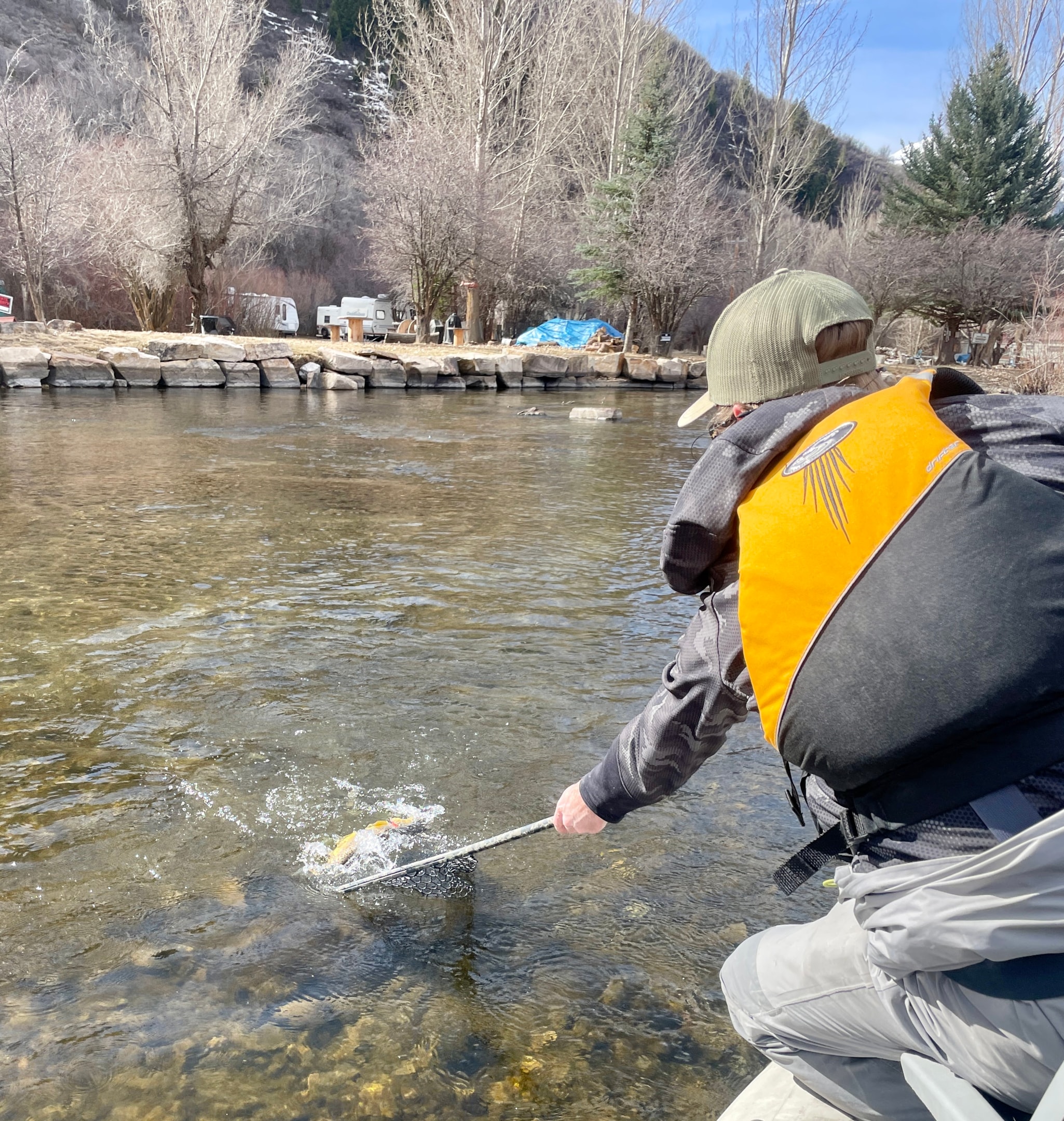Angler nets a fish out of the boat