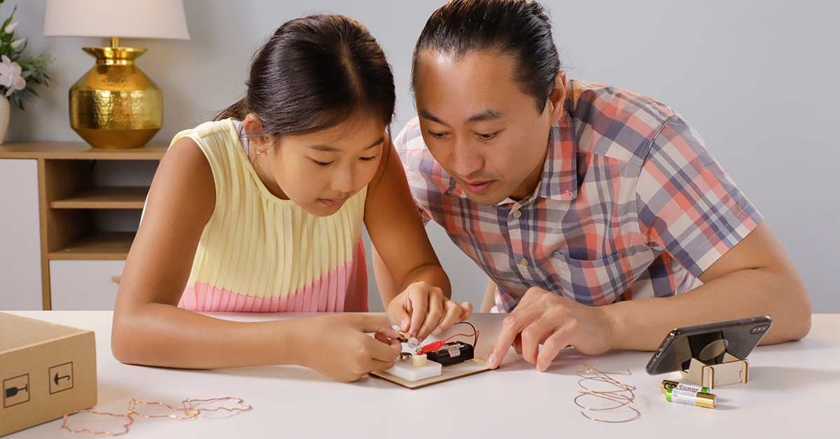 A parent and a child looking at content related to STEM