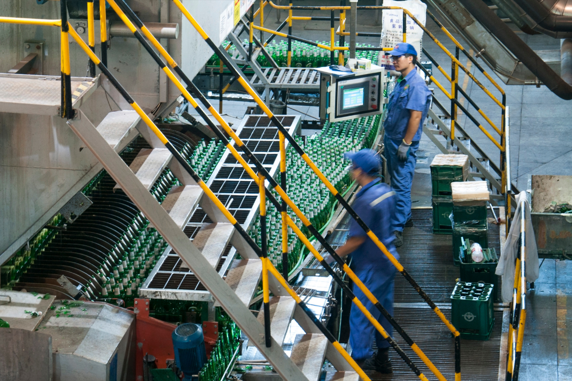 Workers at a functional beverage manufacturing plant overseeing large-scale production
