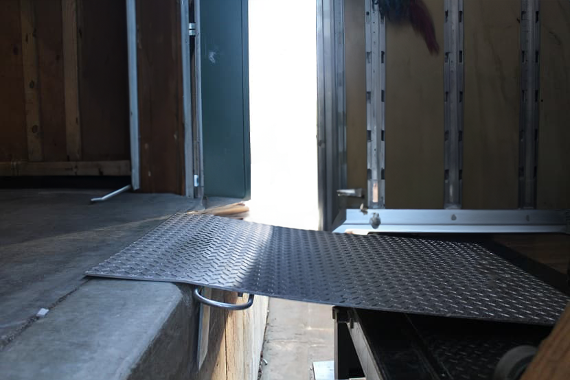 A dock plate connecting a loading dock to a truck