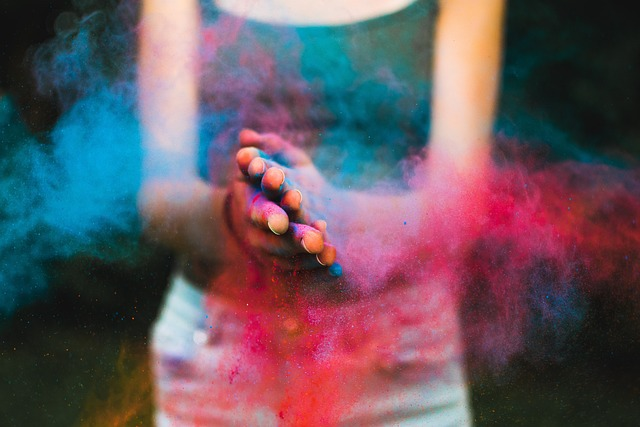 woman clapping hands with colour powder blue and red