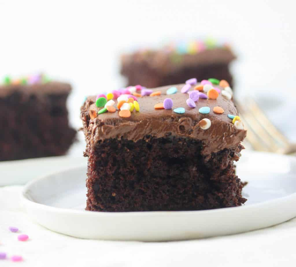 slice of chocolate cake with chocolate frosting on a plate