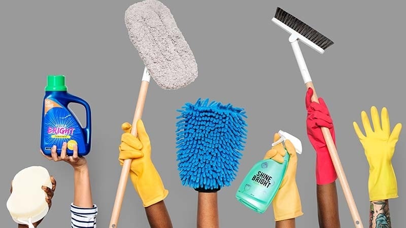 People holding up different cleaning supplies