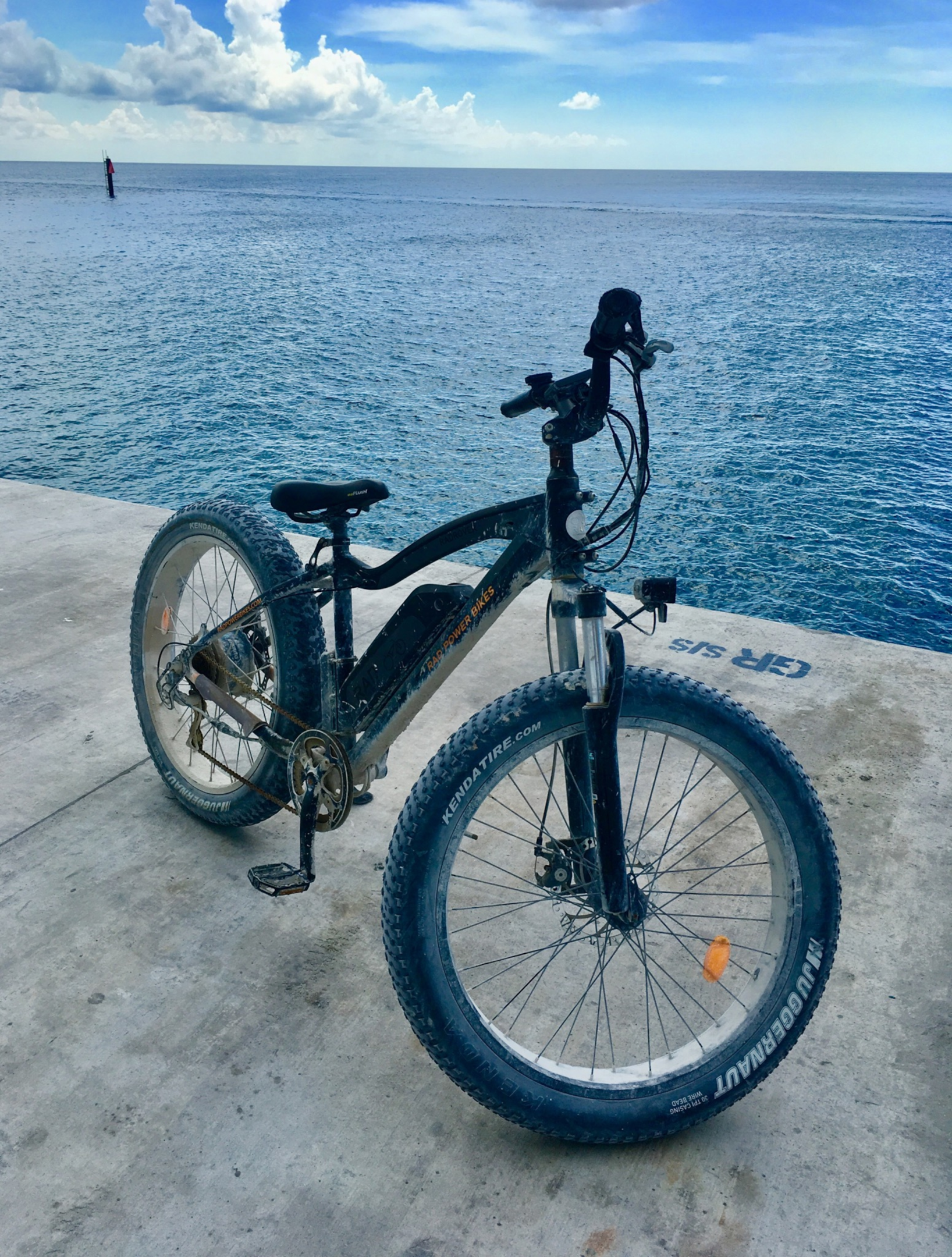 A person riding an electric fat bike with a motor and battery
