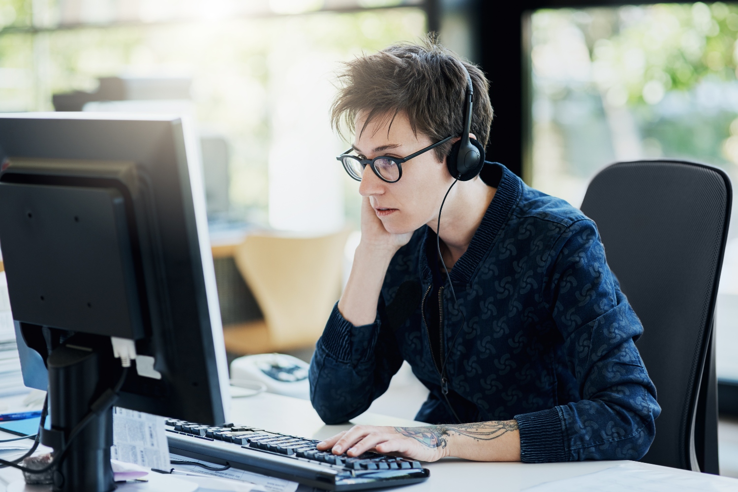 Manager listening intently to a remote employee.