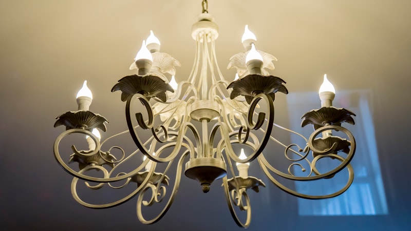 Chandelier with multiple lit LED candle bulbs