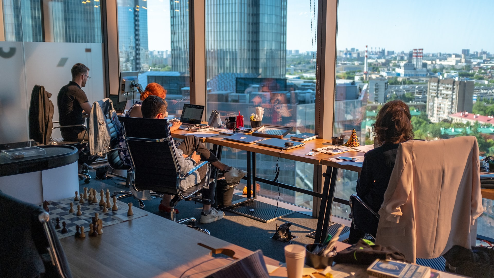 Bunch of Legal translators sitting in their office in front of a glass window