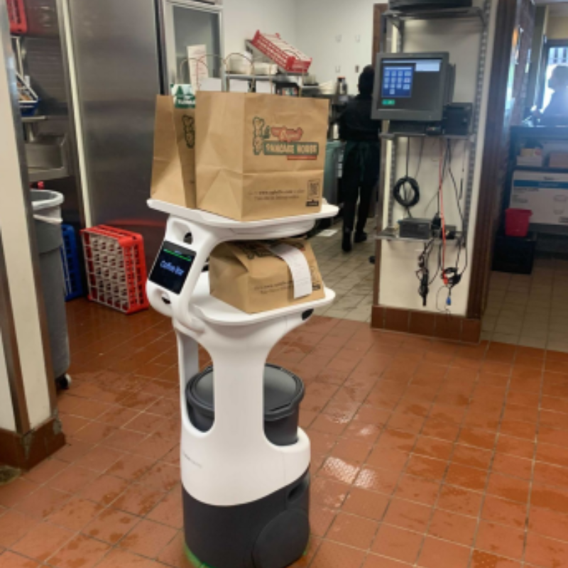 A photograph of Servi the service robot transporting items.