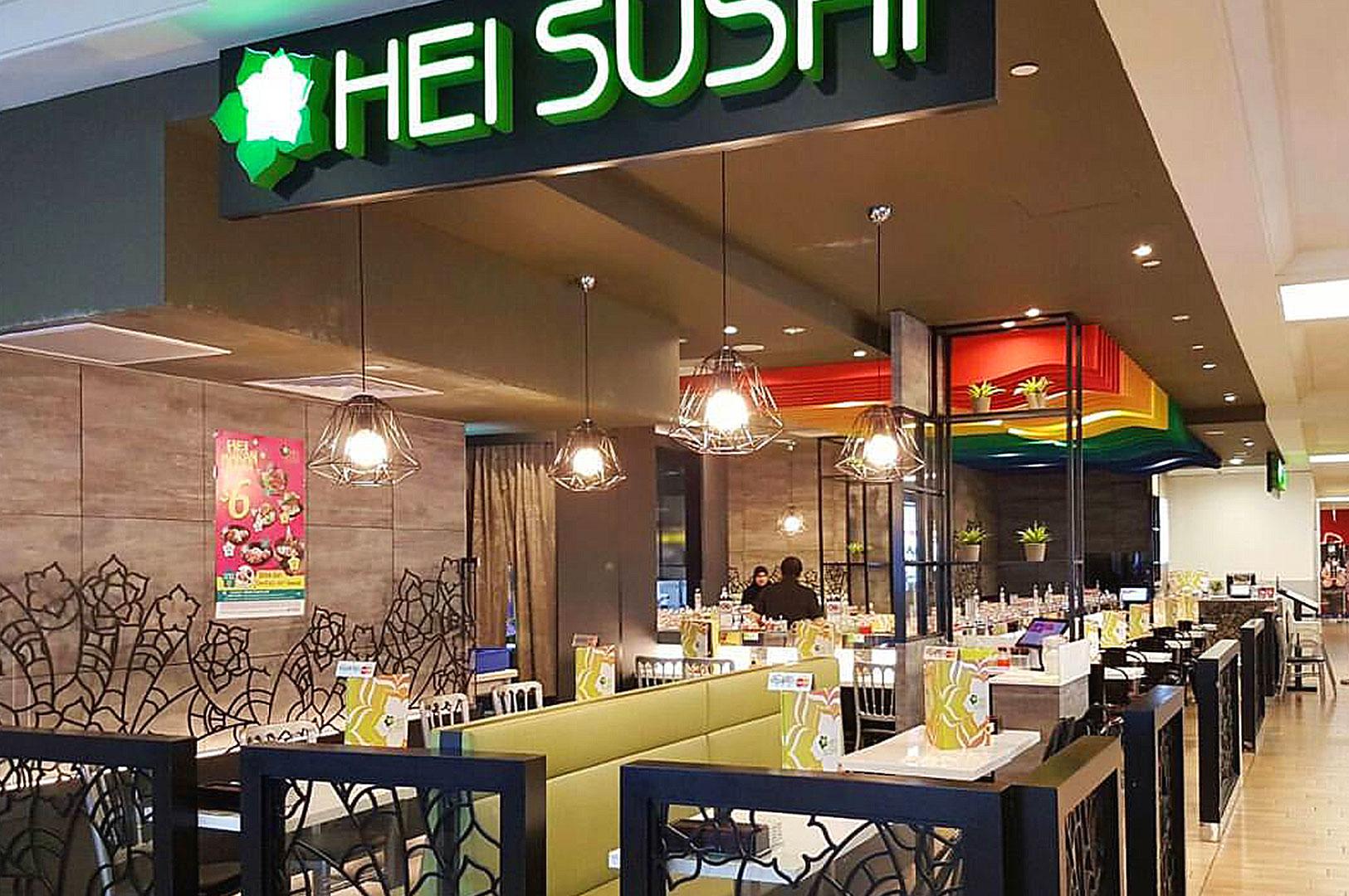 Dining area inside Hei Sushi restaurant with booths.