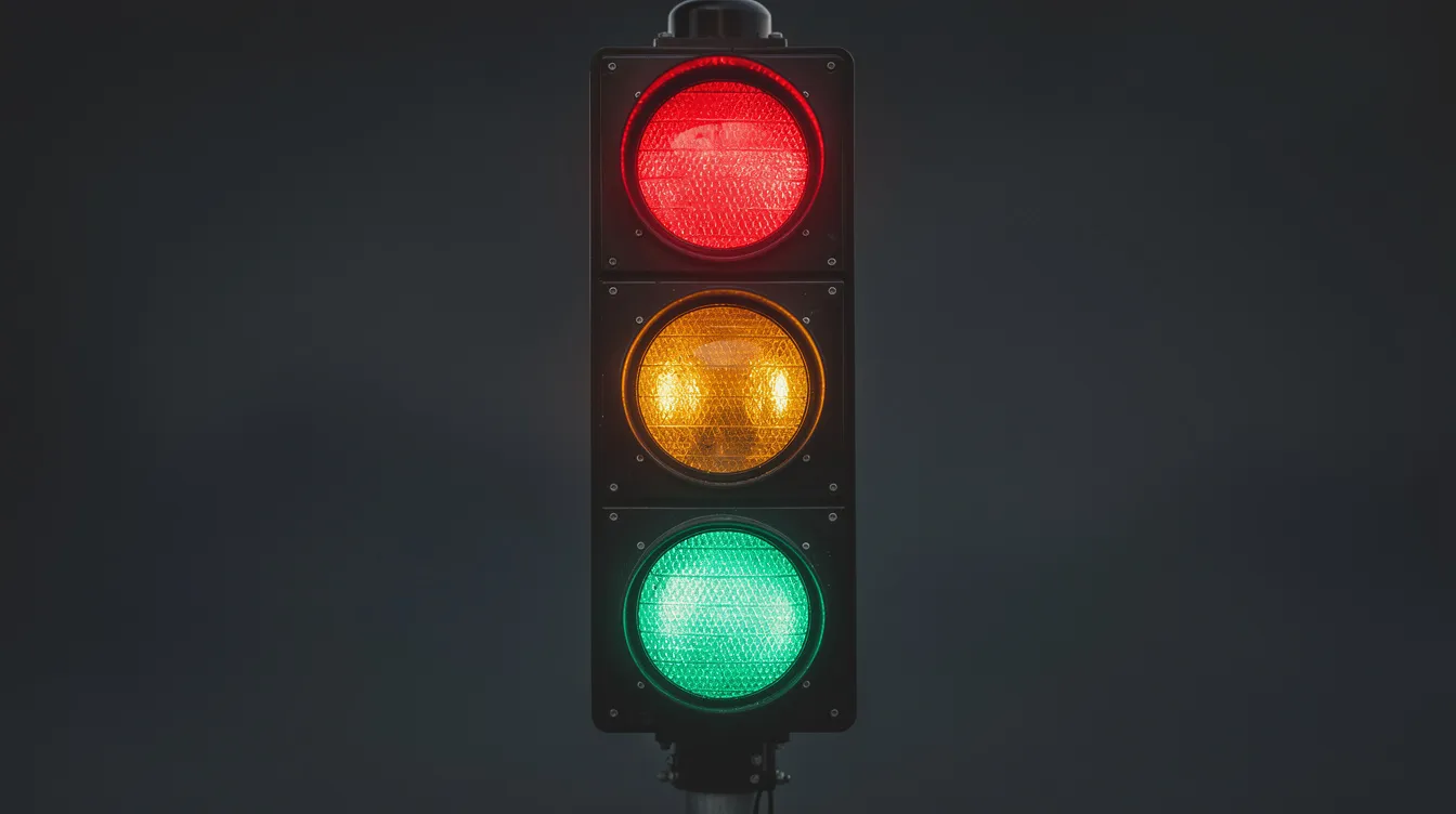 The Importance of Safe Words in BDSM 2 - Consent Culture A glowing traffic light with red, yellow, and green lights stands out against a dark minimal background, symbolizing the importance of setting boundaries and using safe words in BDSM play to ensure safety and comfort among all parties involved. The red light represents the need to stop immediately if anyone feels uncomfortable, while the green light encourages open communication and trust in the relationship.