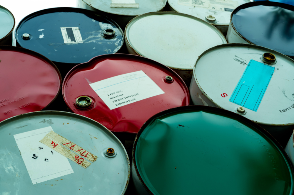 Group of labeled oil barrels, highlighting California's hazardous waste regulations and compliance.