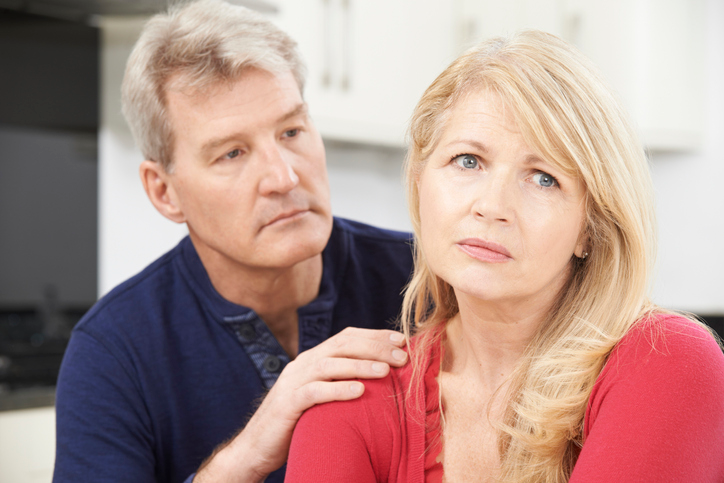 An image of a worried, anxious married couple. 