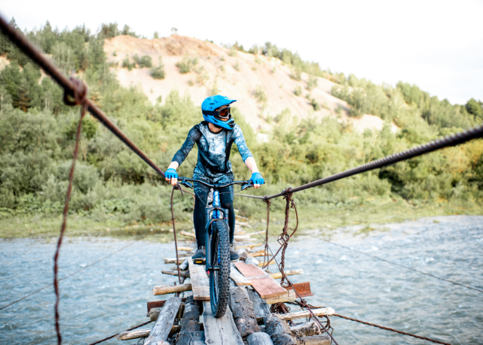 A mountain biker performing a trick on a slopestyle course