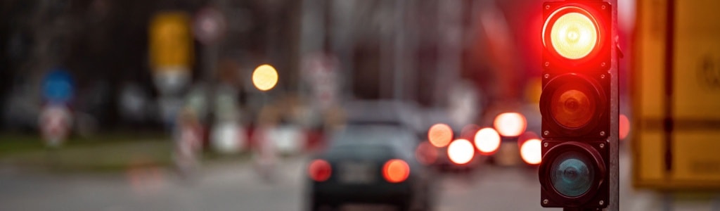 An image a a flashing red light at a traffic signal intersection 