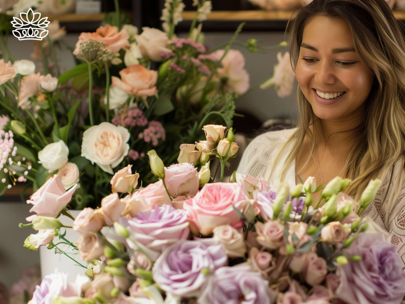 A delighted woman with a radiant smile appreciating a graceful congratulations gift bouquet of blush roses and lilac flowers, reflecting skilled floral craftsmanship in a serene setting—Fabulous Flowers and Gifts same day delivery