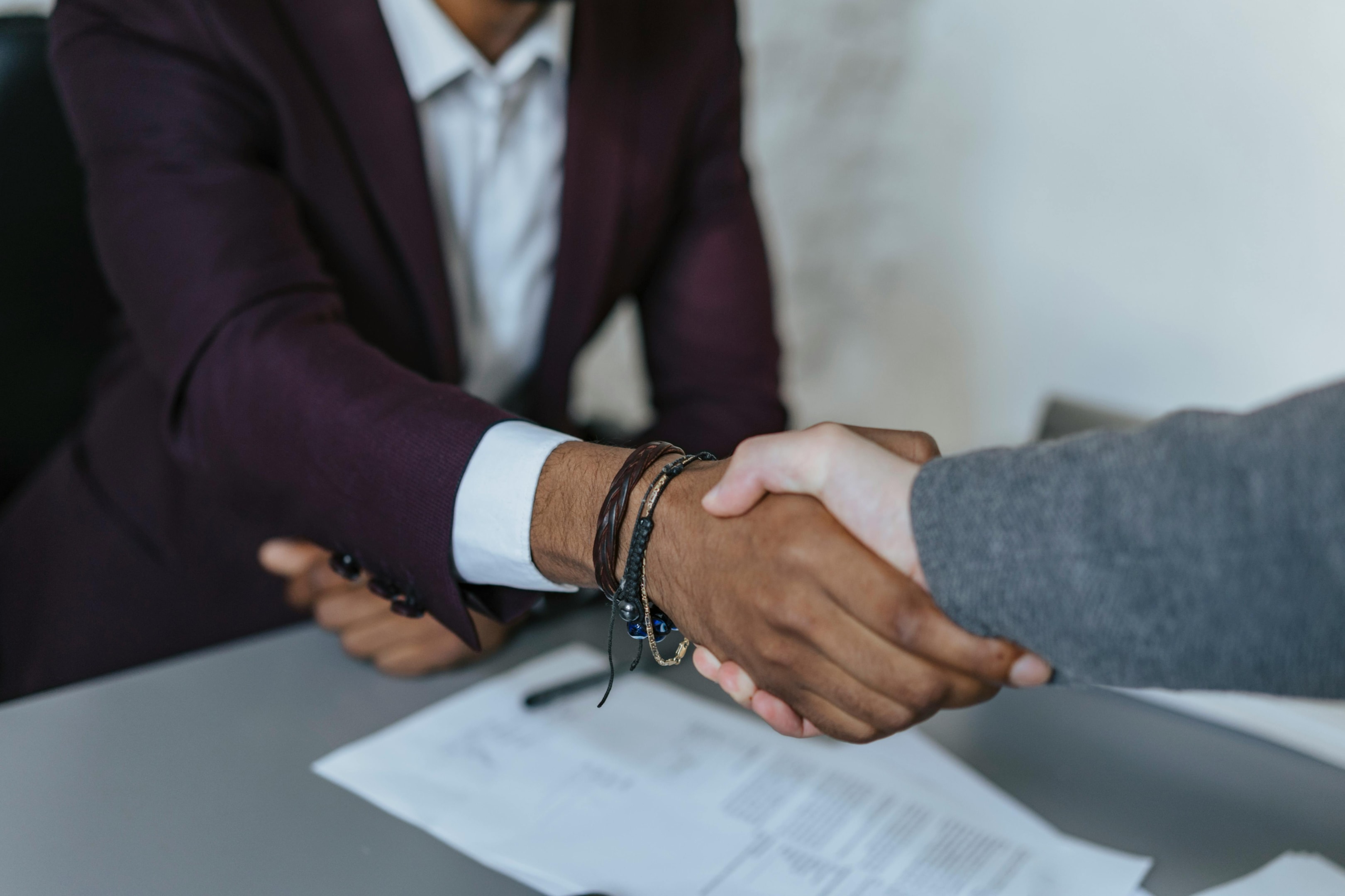 Handshake between property manager and another real estate professional. 