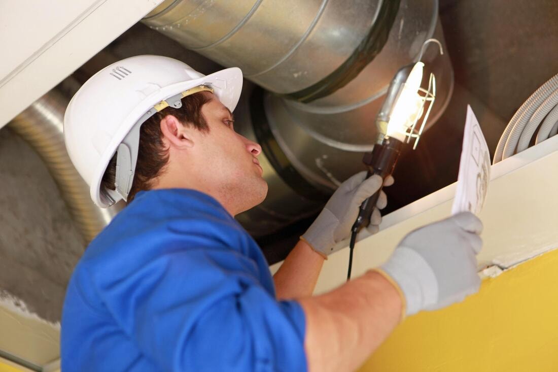 a professional checking a clients ducts for proper sealing