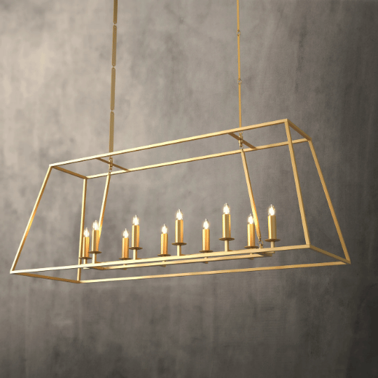 A farmhouse chandelier design featuring a rectangular open metal frame in a warm gold finish with candle-style lights, combining rustic charm with modern elegance for dining or kitchen spaces.