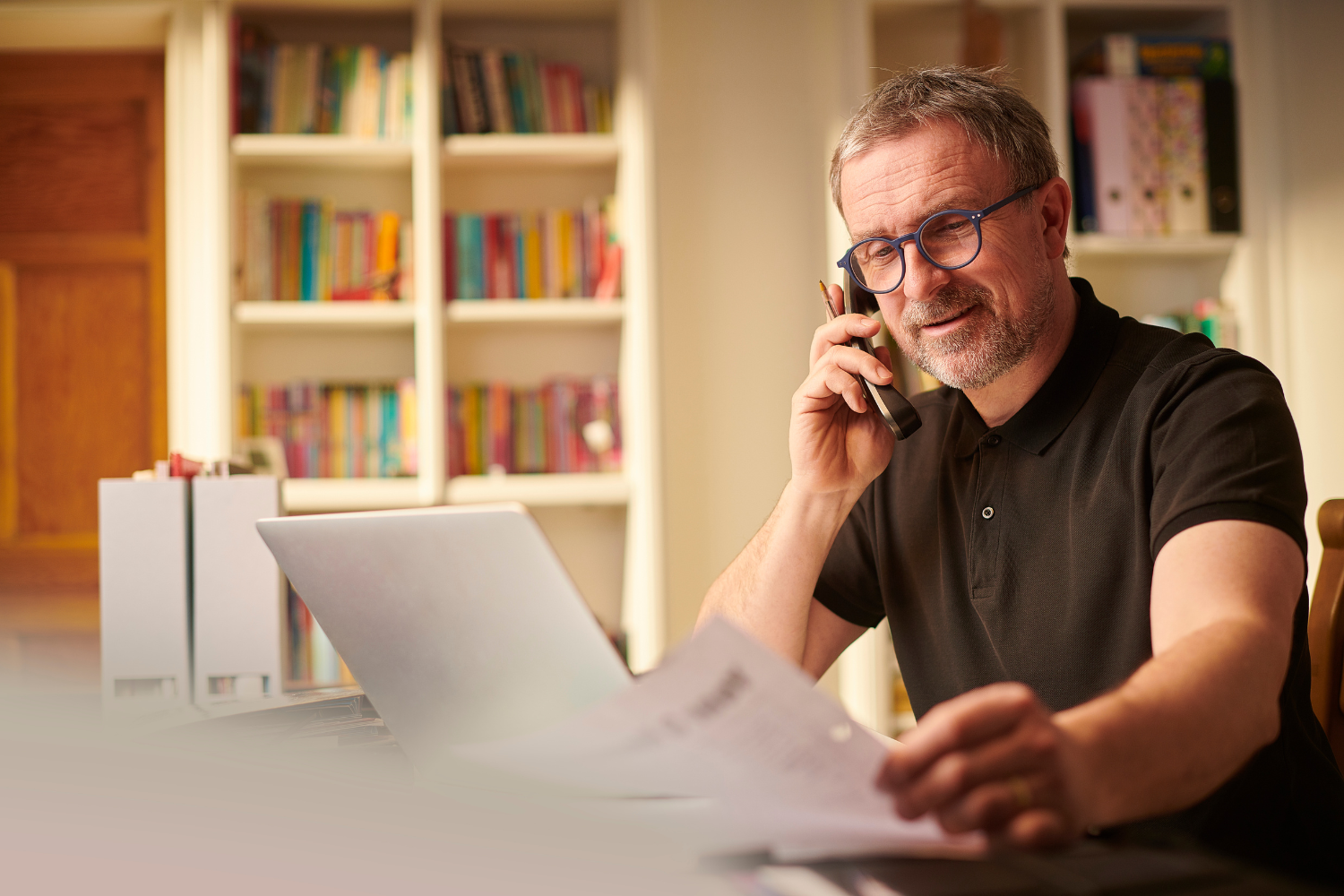 A smiling business owner on his phone.