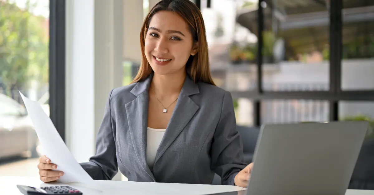 A woman reviewing expenses and financial records on her laptop while managing accounting for sole traders.