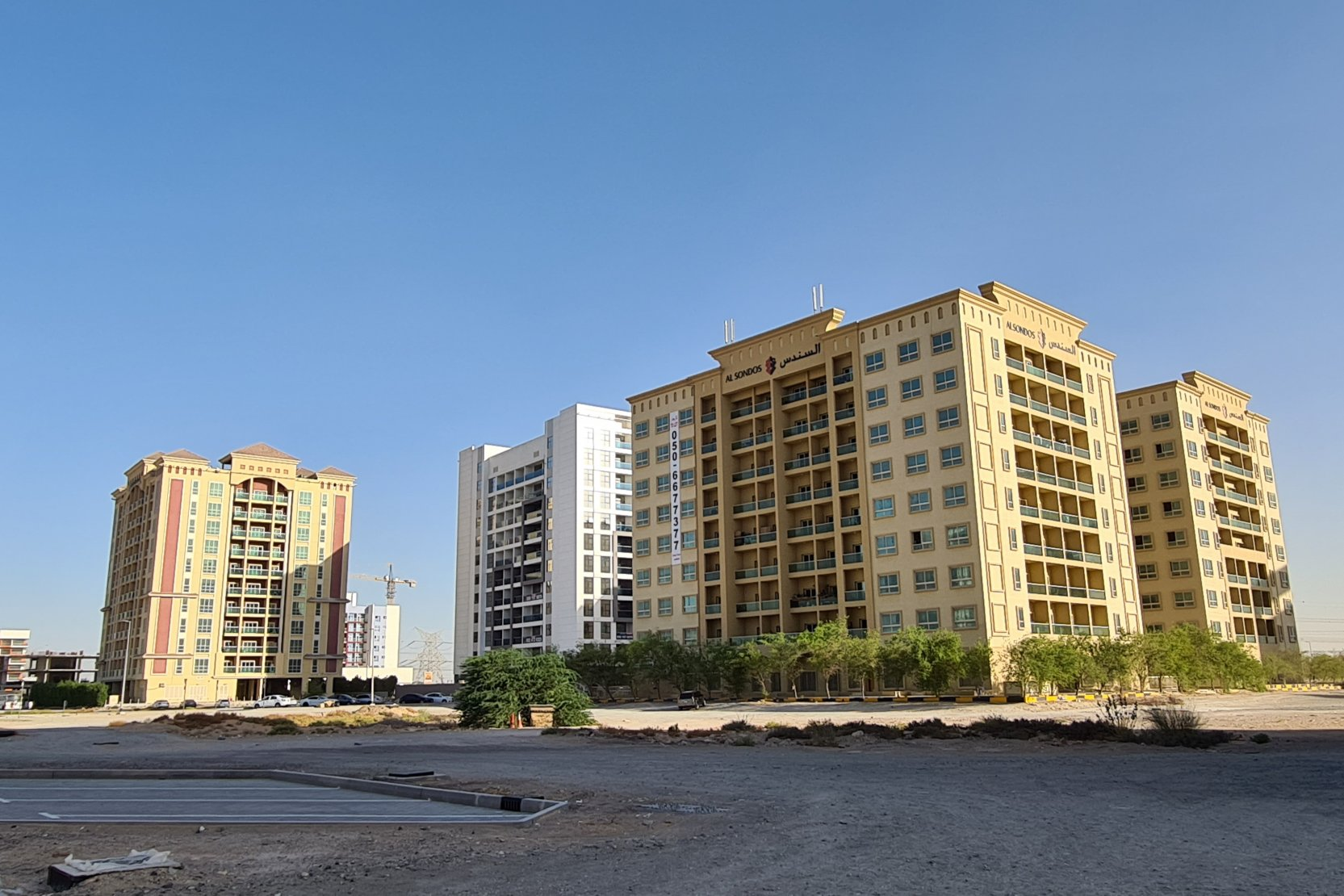 residential towers surrounded by desert in a new area of business bay