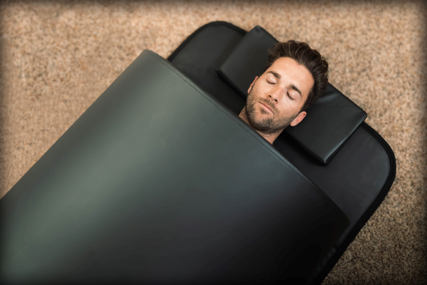 portable infrared sauna dome, a man laying inside with his head out