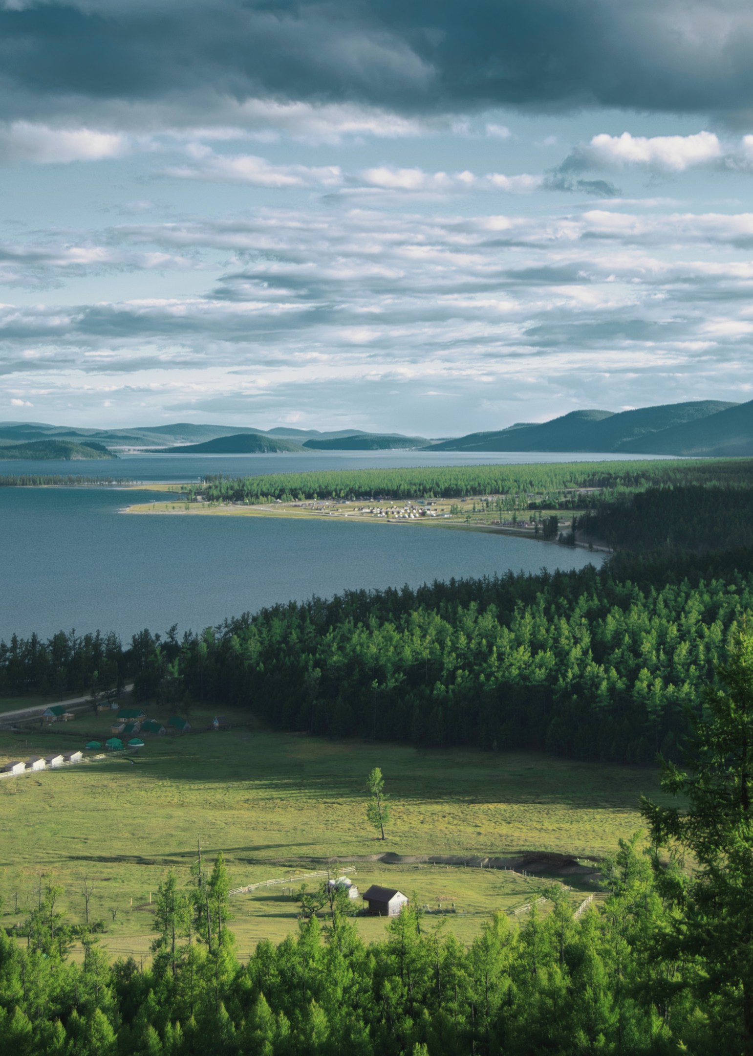 A stunning aerial view of Khuvsgul Lake, showcasing its crystal clear waters and surrounding mountainous terrain.