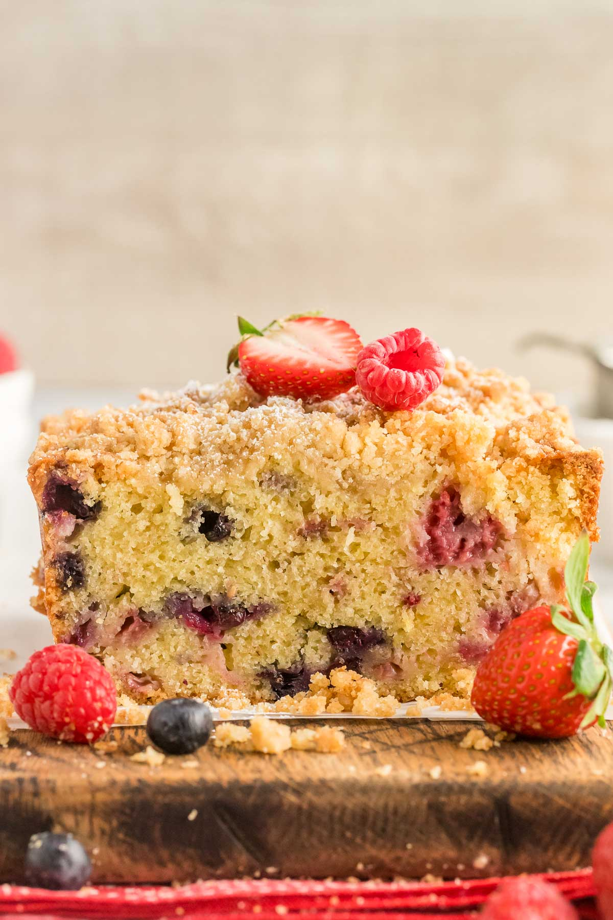 mixed berry loaf bread cut in half topped with berries