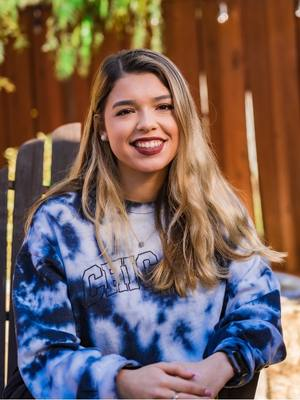 Girl wearing a tie-dye sweatshirt. Depending on your fonts, your own text may be hard to read on a tie-dye. 