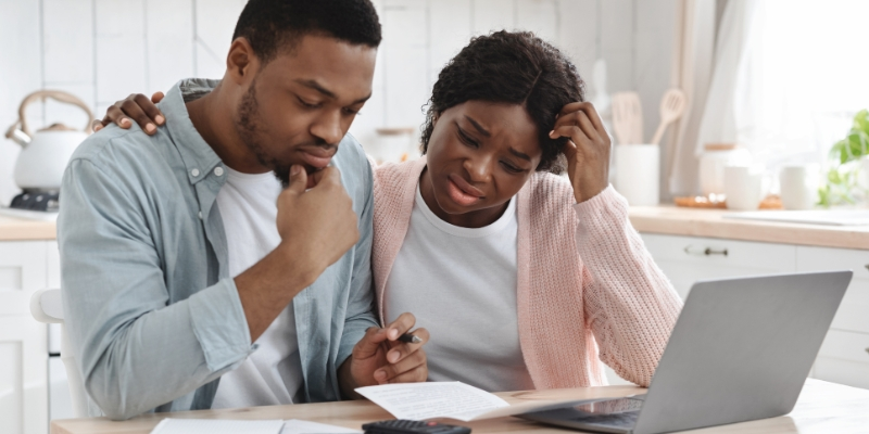 A person looking at their home equity loan and calculating their outstanding debt