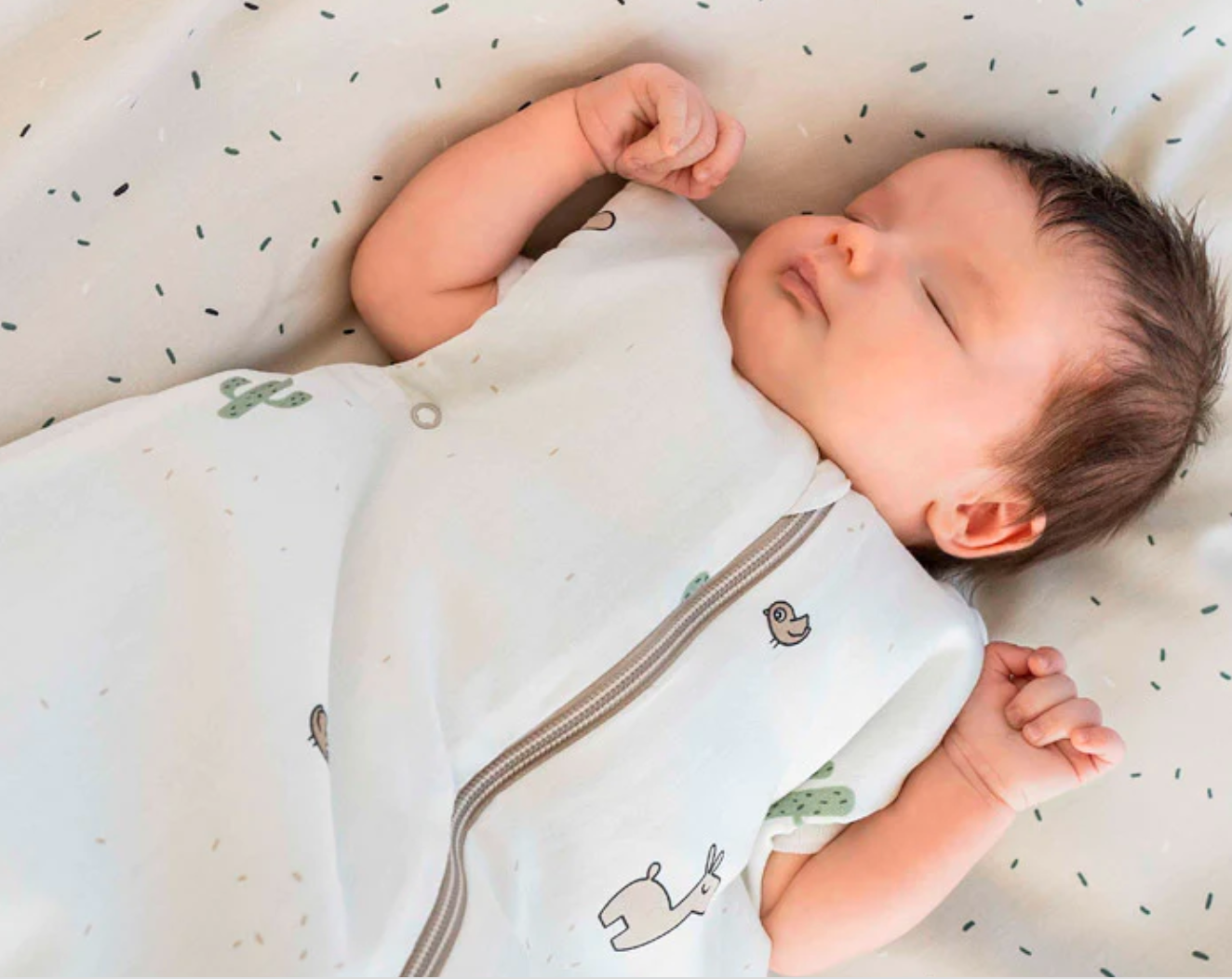 A baby sleeping peacefully in a sleep sack benefits of sleep sacks