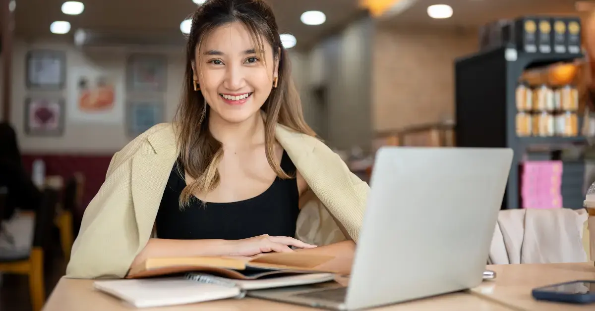 Female creator reviewing her budget to see what is take-home income after taxes and deductions.