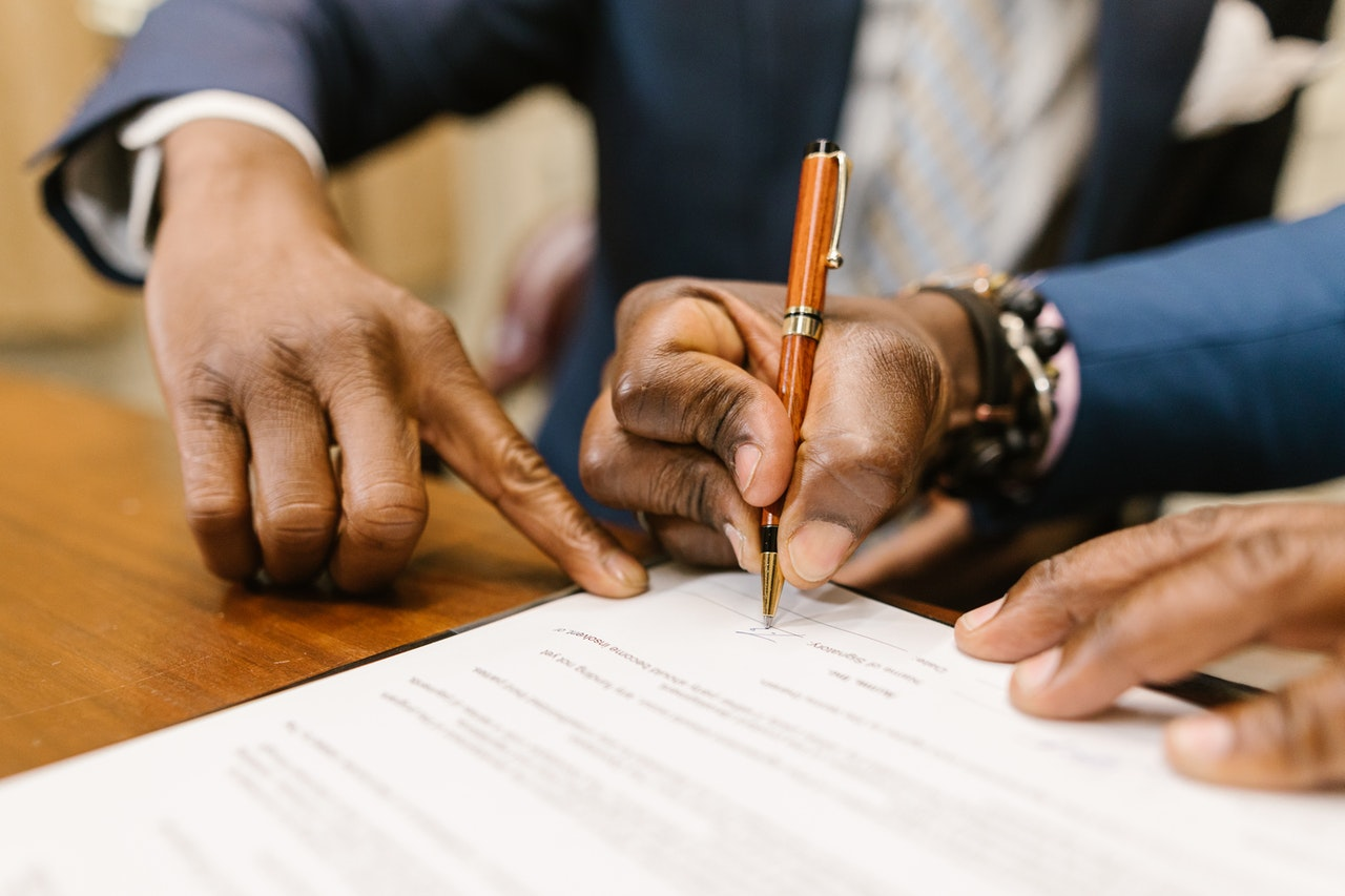 guy signing a translate document after reading entire word document