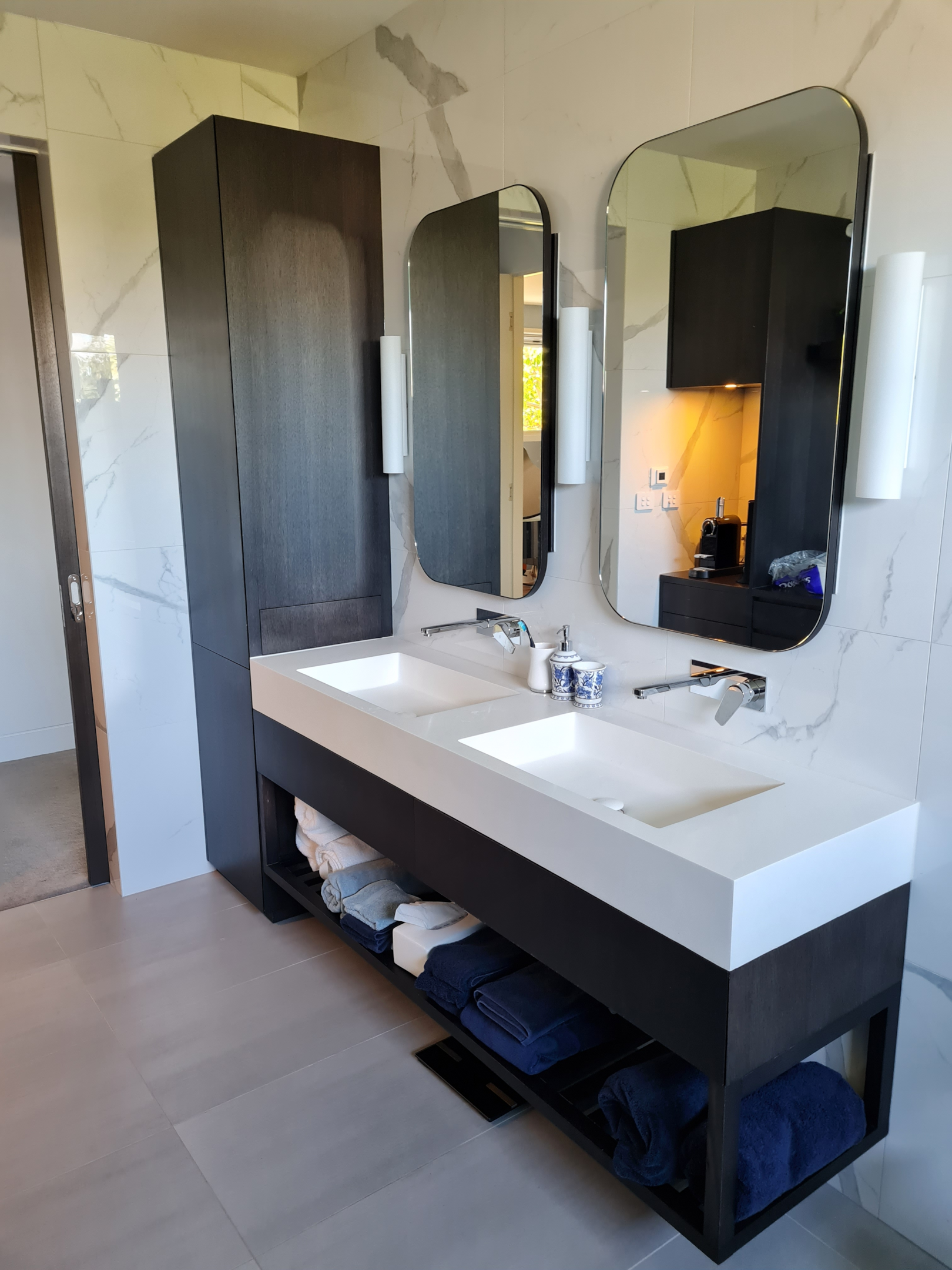 A wall hung vanity in a larger bathroom, with plenty of storage and feature style