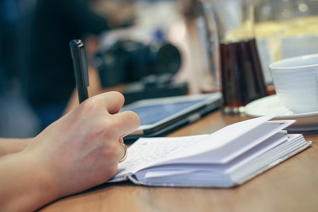 A person plotting their novel in a notebook.