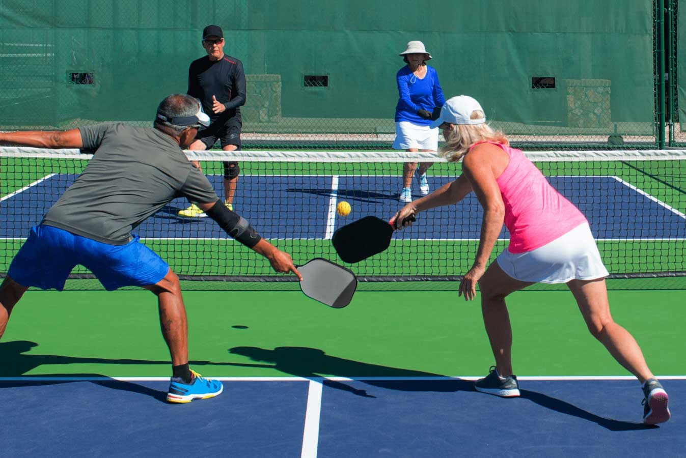 A vibrant scene of people playing pickleball, highlighting its popularity.