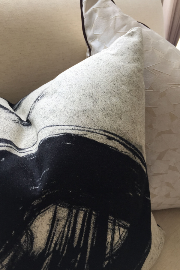 mixing patterns doesn't always mean bold colour and pattern; sometimes, neutral color palettes are perfect for the overall look like these pillows
