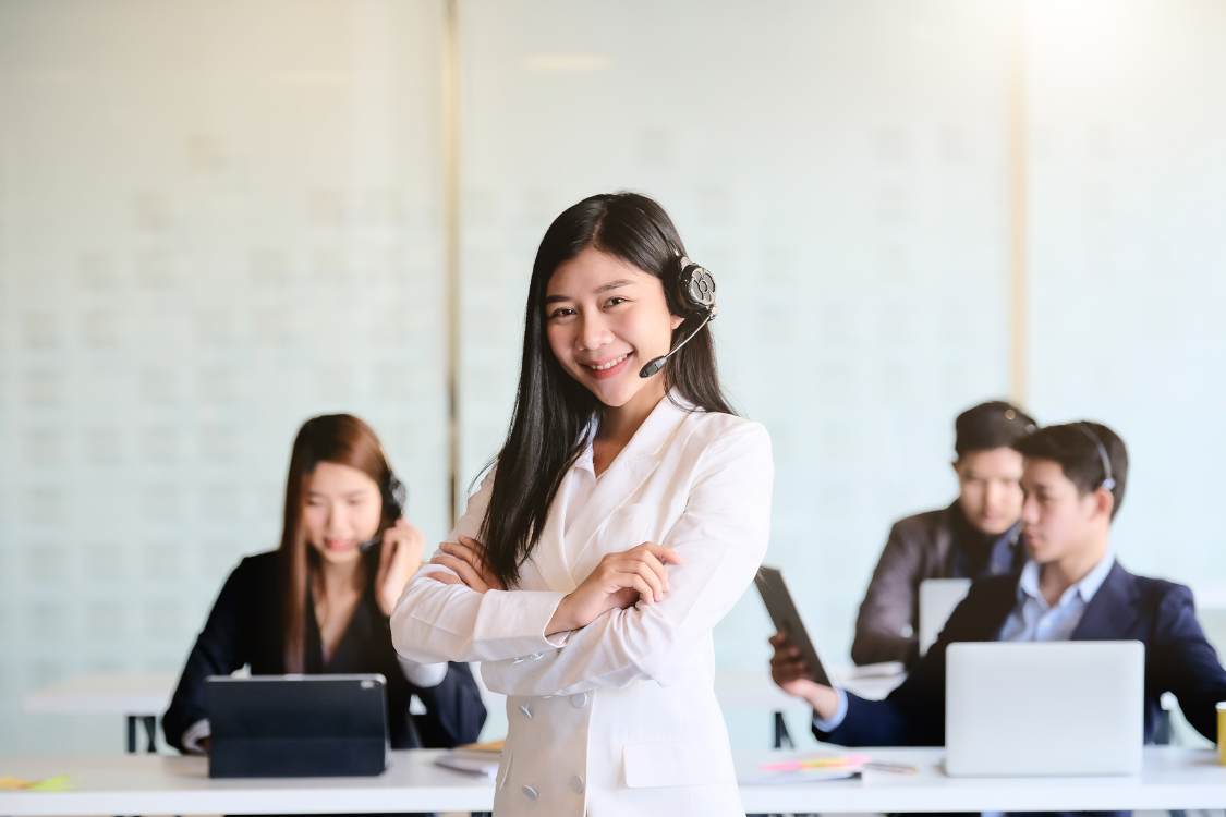 Filipino virtual assistant smiling confidently in an office with a headset