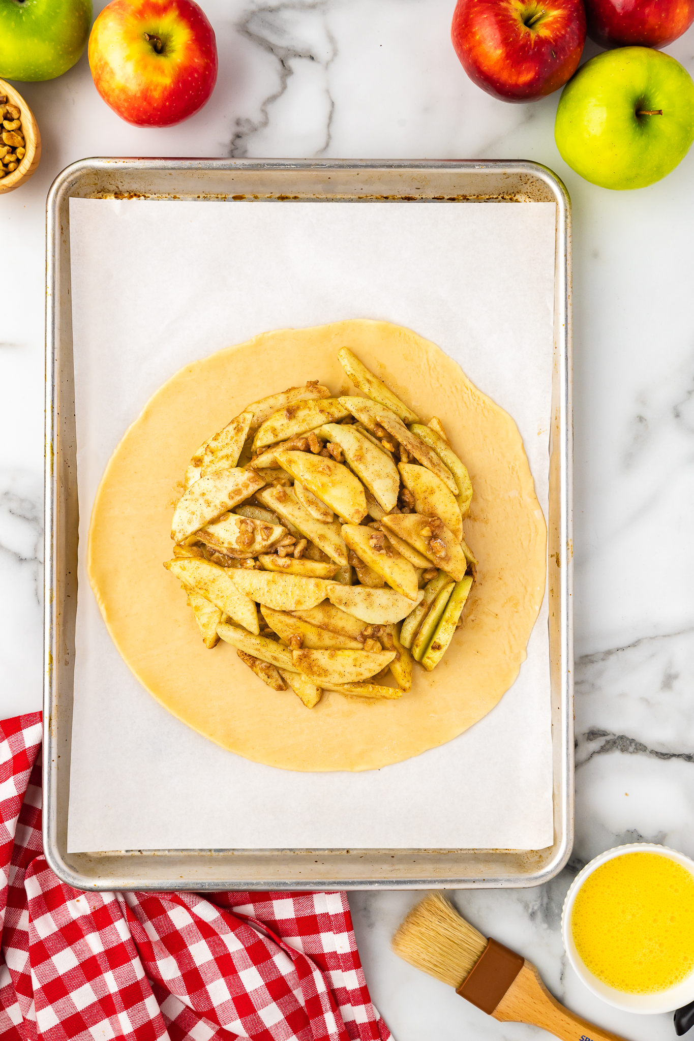 apple crostata filling mounded in center of pie dough