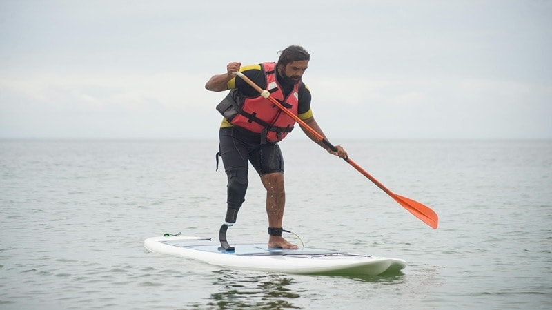 A Surfer with a Life Jacket On