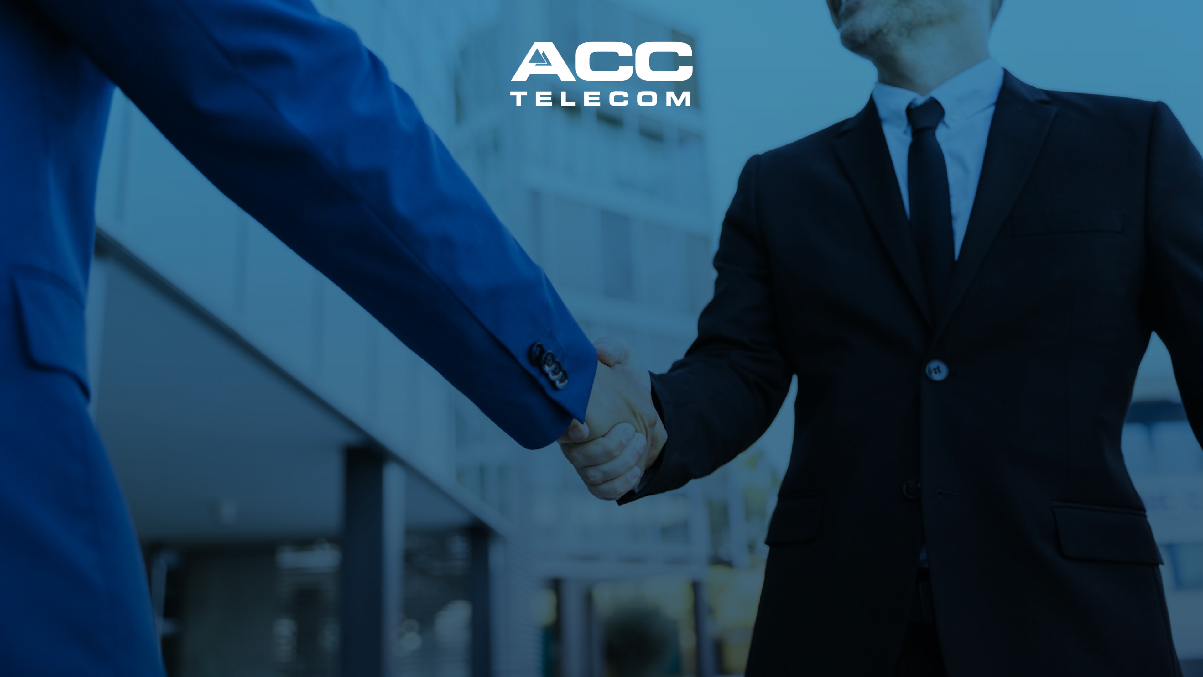 Two business professionals in suits shaking hands outdoors, representing partnership in video security, threat detection, and AI surveillance camera solutions.