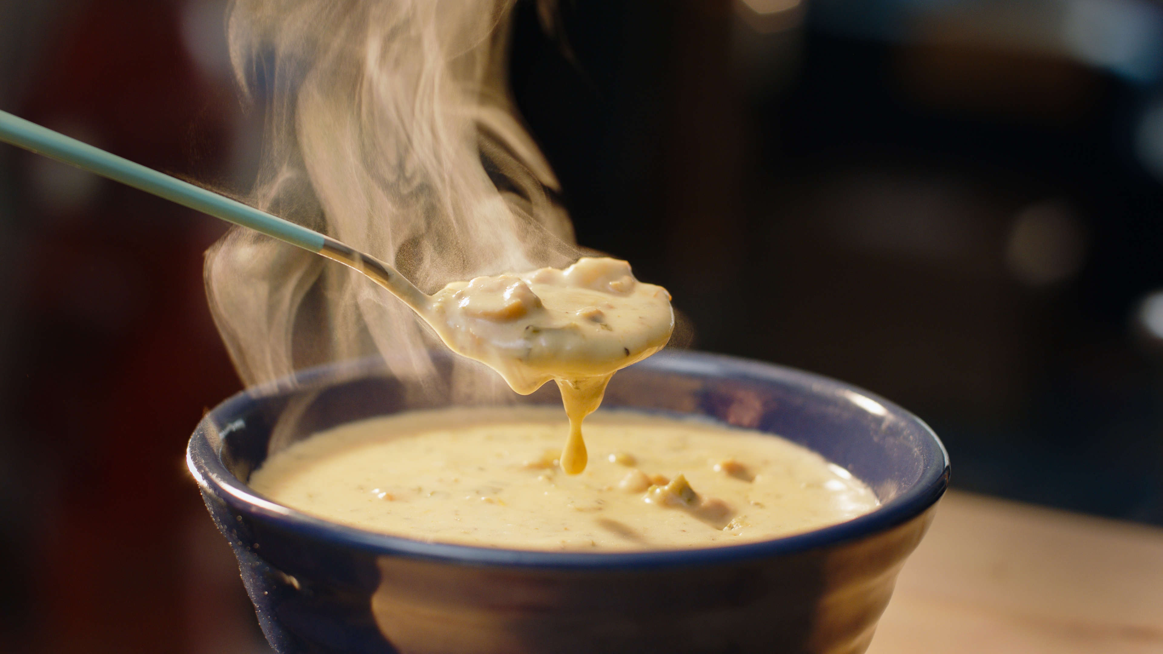 A bowl of creamy chicken soup with shredded chicken, cream cheese, and sour cream