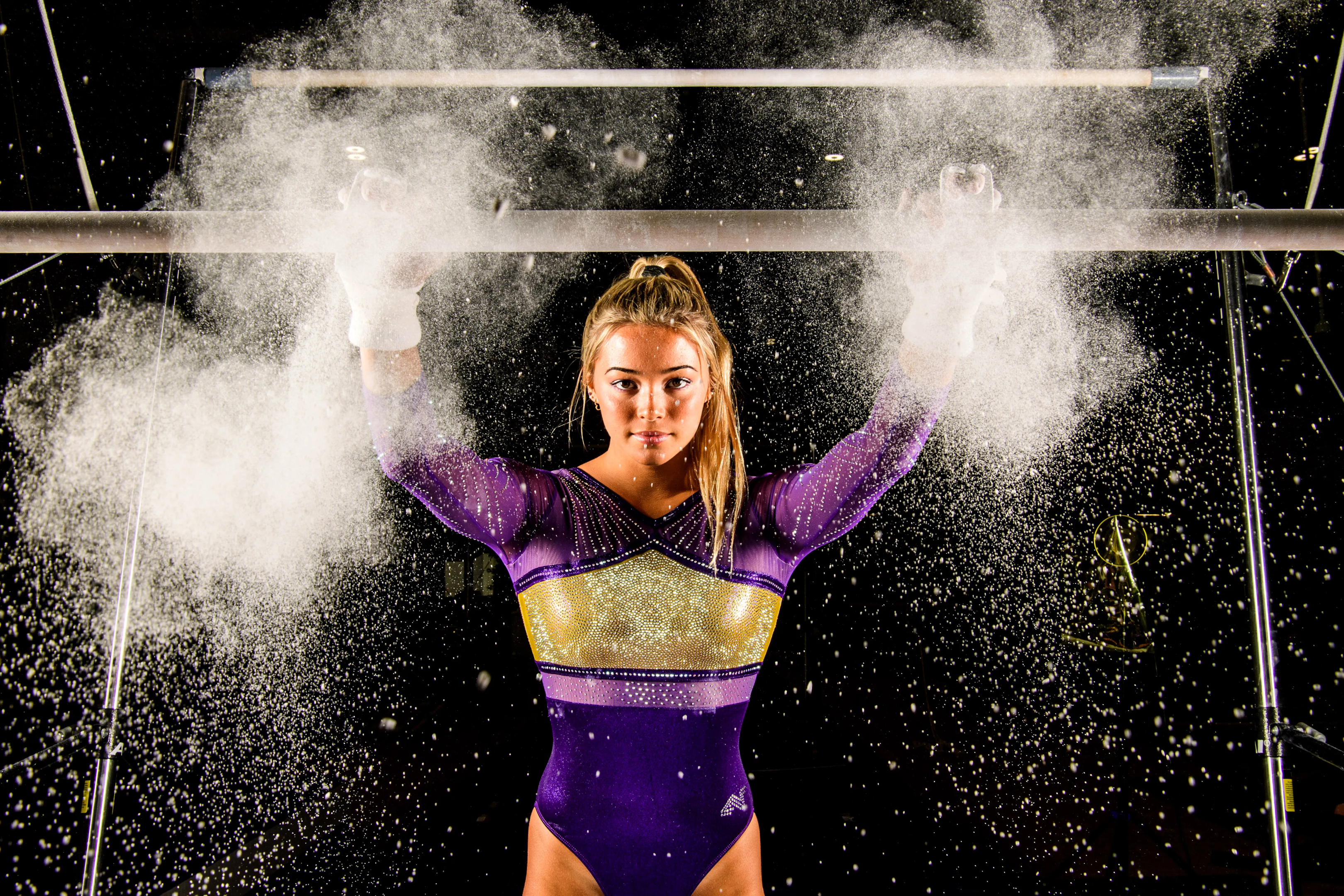 LSU gymnast Olivia 'Livvy' Dunne smiling and posing in LSU gymnastics uniform, showcasing her status as one of NIL's top-earning female athletes.