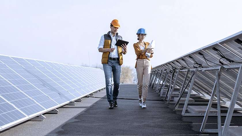 People inspecting solar panels