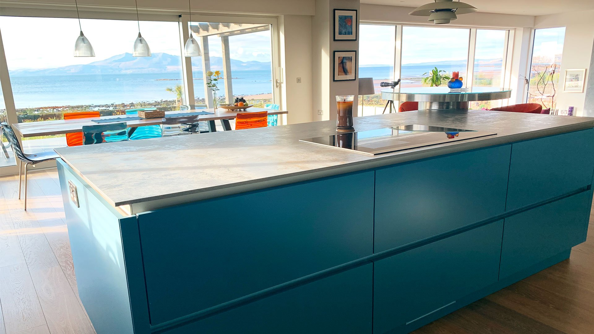 A grand kitchen island with seating arrangements, wine coolers and integrated sinks