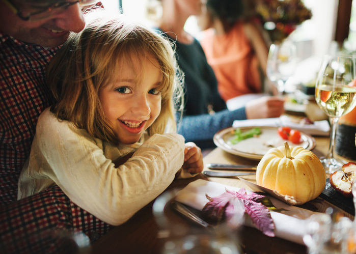 Dad hugging his little girl at the table. 