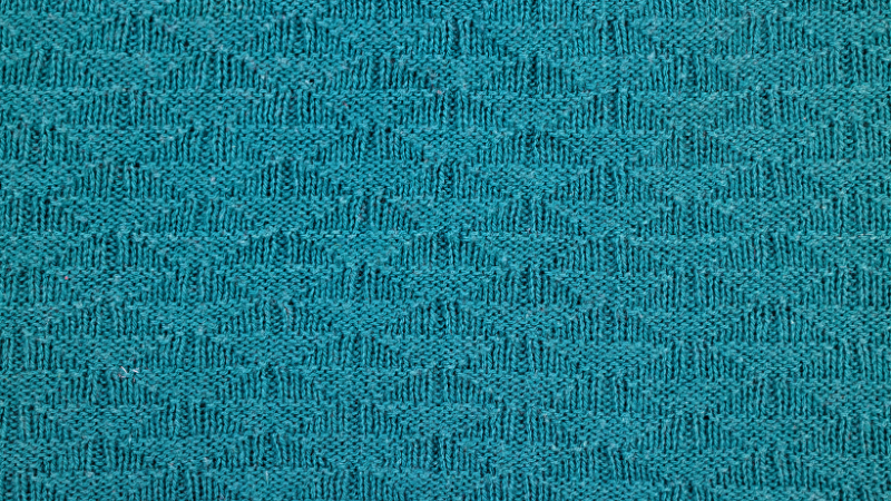 A close up view of a teal colored modal fabric