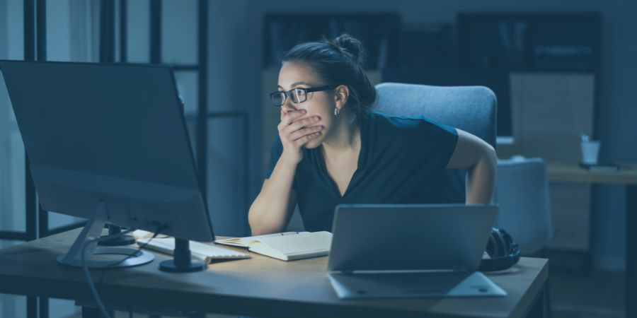 Woman in shock looking at computer screen